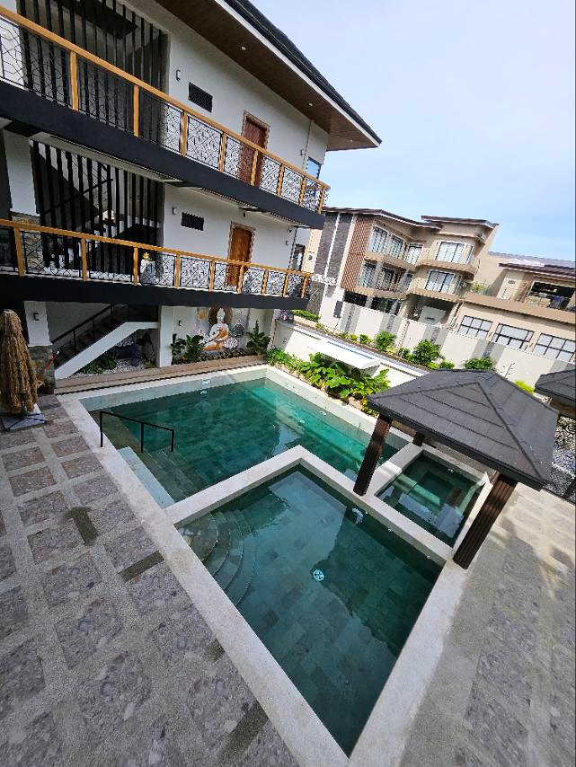 Elevated portrait view of the pools, pavilion and balconies surrounding the courtyard.
